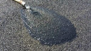 Running hose on asphalt pavement