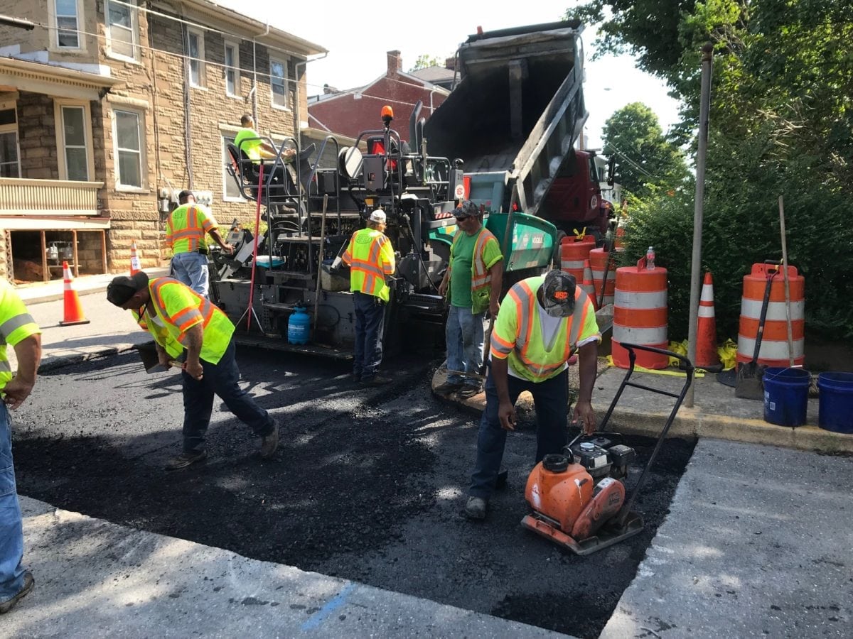 construction workers paving a city street asphalt street repair